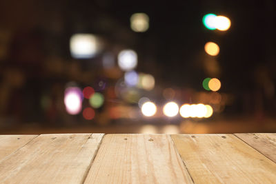 Close-up of table against defocused illuminated lights