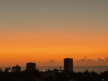 Cityscape against sky during sunset