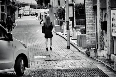 Woman walking on street in city