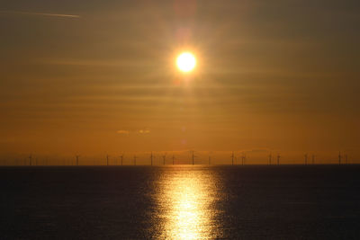 Scenic view of sea against sky during sunrise wind turbines llandudno 