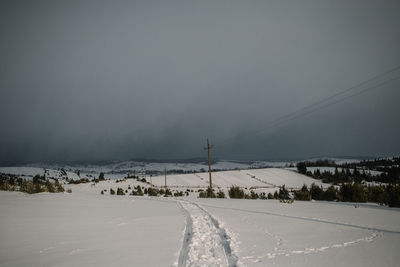 Scenic view of snow field against sky