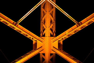 Low angle view of bridge against black background