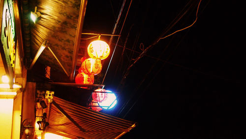 Low angle view of illuminated lights at night