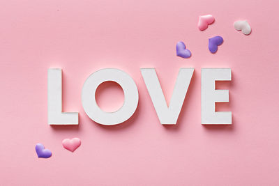 Close-up of multi colored text on pink background