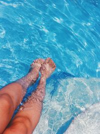 Low section of woman swimming in pool