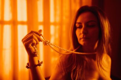 Close-up of shirtless woman wearing necklace