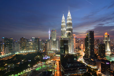 Illuminated cityscape against sky at night