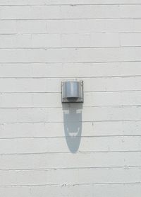 Close-up of light bulb on wall