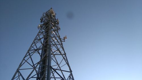 Low angle view of communications tower against clear sky