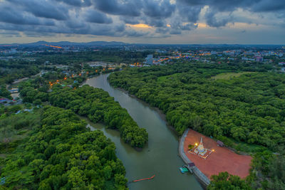 High angle view of river amidst cityscape against sky