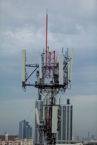 View of communications tower against cloudy sky