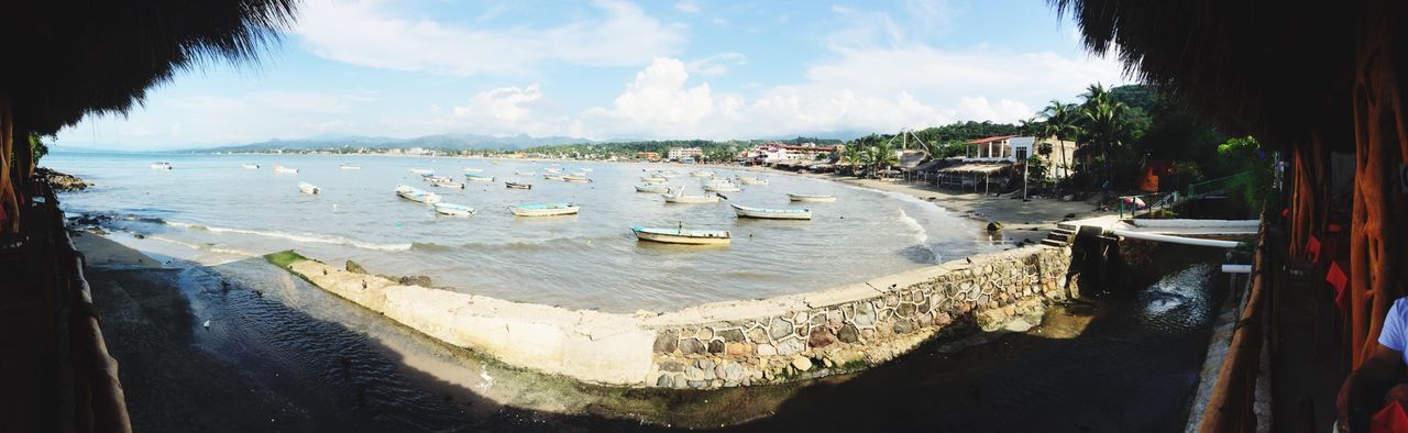 water, sky, bird, sea, beach, animal themes, building exterior, built structure, nautical vessel, architecture, moored, transportation, wildlife, shore, animals in the wild, incidental people, nature, cloud - sky, cloud