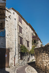 Low angle view of building against clear blue sky