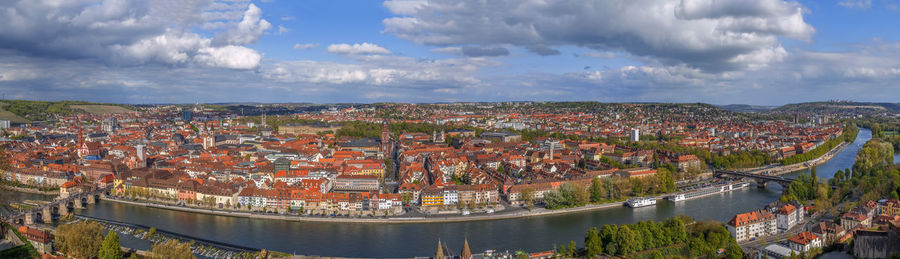 High angle view of river by buildings against sky