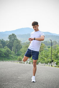 Full length of man exercising on road