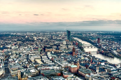 High angle view of city buildings against sky during sunset