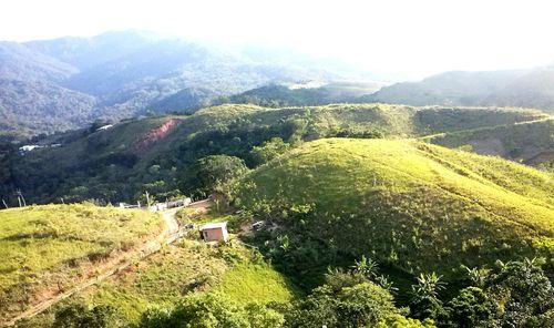 Scenic view of field and mountains against sky