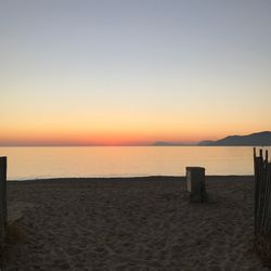 Scenic view of sea against clear sky during sunset