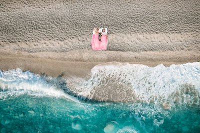 Aerial view of couple on the beach
