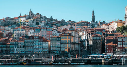 Buildings in city against clear sky