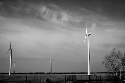 Windmill on field against sky