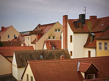 Exterior of houses in town against sky