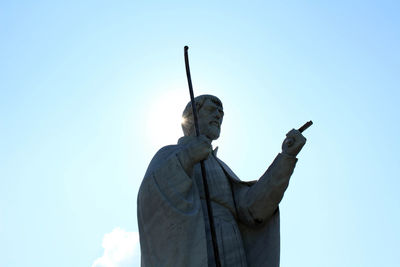 Low angle view of statue against blue sky