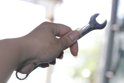 Close-up of hand holding finger