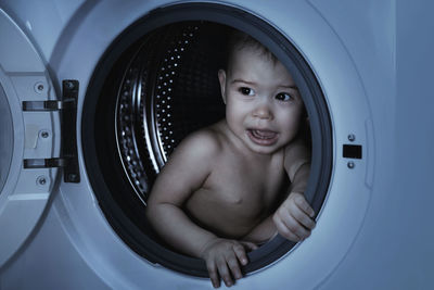 High angle view of boy in washing machine