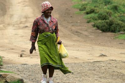 Full length of a man walking on road