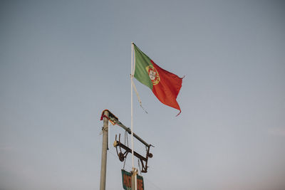 Low angle view of flag against clear sky