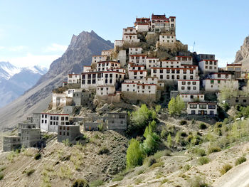 Buildings in town against sky