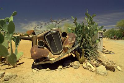 Abandoned vehicles on landscape
