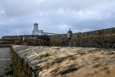 View of old building against cloudy sky