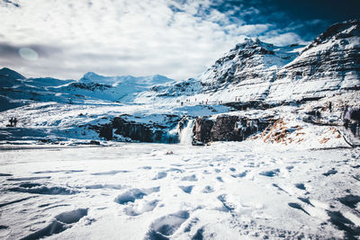 Scenic view of snow covered mountains against sky