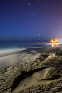 Scenic view of beach against sky at night