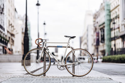 Racing bicycle locked to bicycle rack