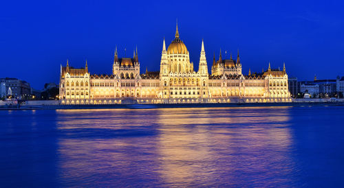 Illuminated city at waterfront