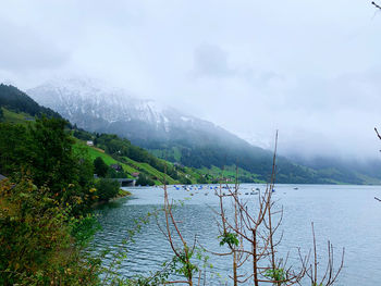 Scenic view of lake and mountains against sky