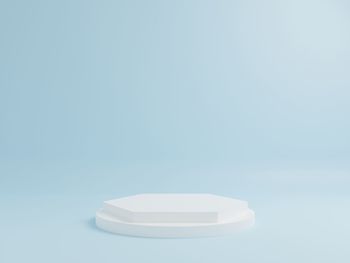 Close-up of white table against blue background