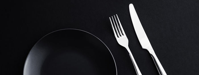 Close-up of empty plate on black background