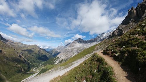 Panoramic view of road by mountains against sky