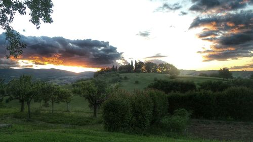 Scenic view of landscape against sky at sunset