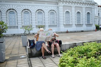 Full length of woman standing by railing