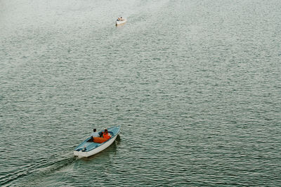 High angle view of man floating on lake