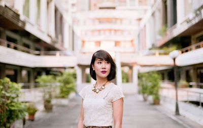 Portrait of young woman standing outdoors