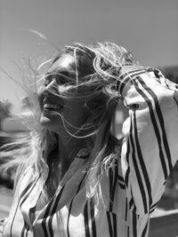 Close-up of smiling woman with tousled hair 