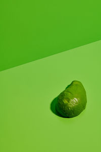 Close-up of fruits against green background