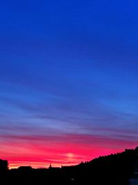 Scenic view of silhouette trees against sky at sunset
