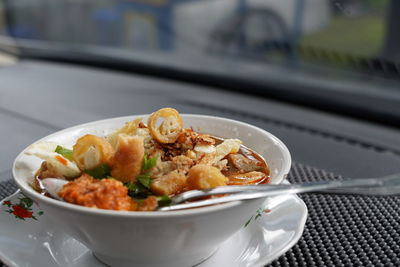 High angle view of noodle soup with spring rolls served in bowl